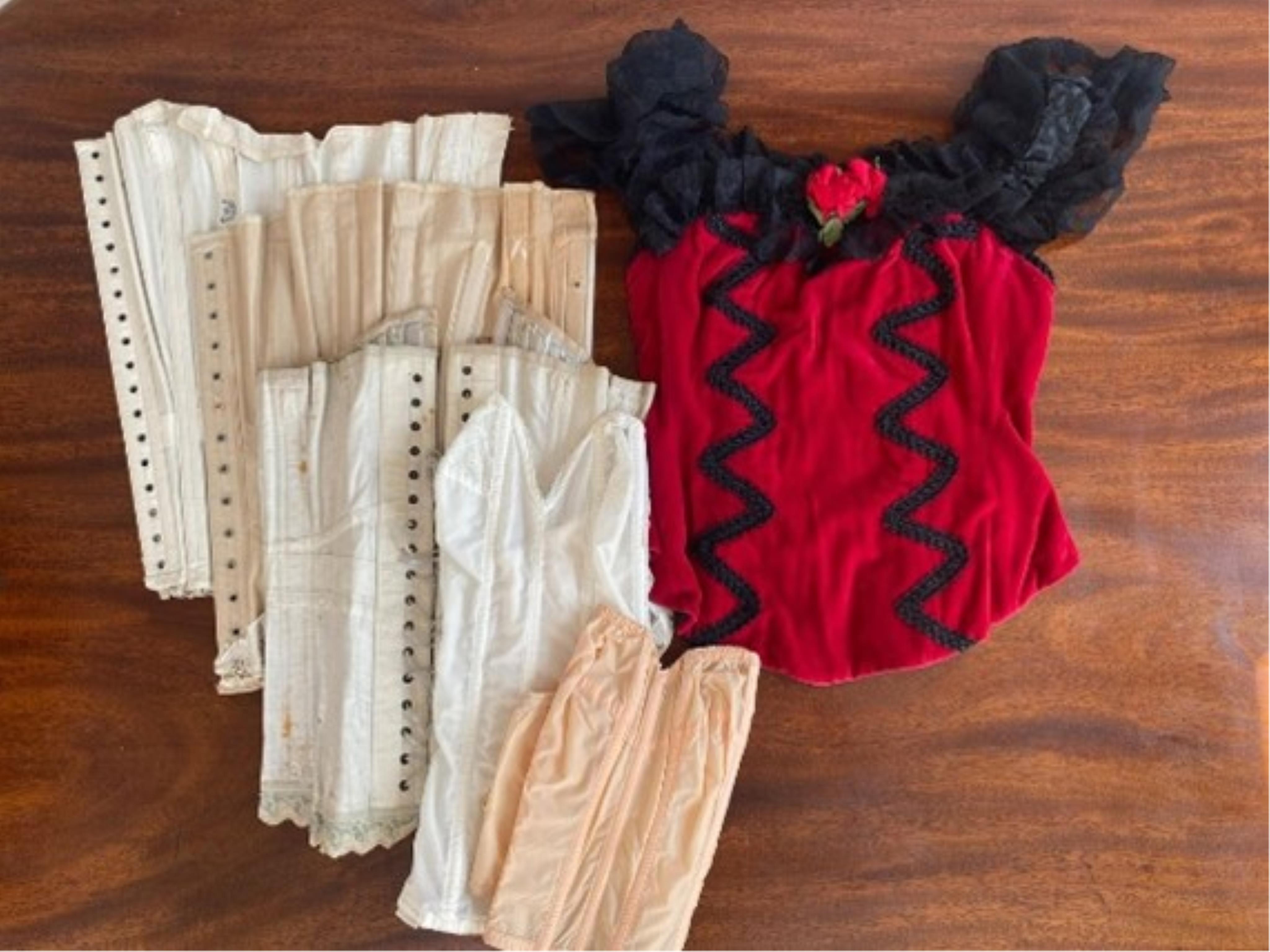 A mixed selection of vintage corsets (one red velvet with lace trim)